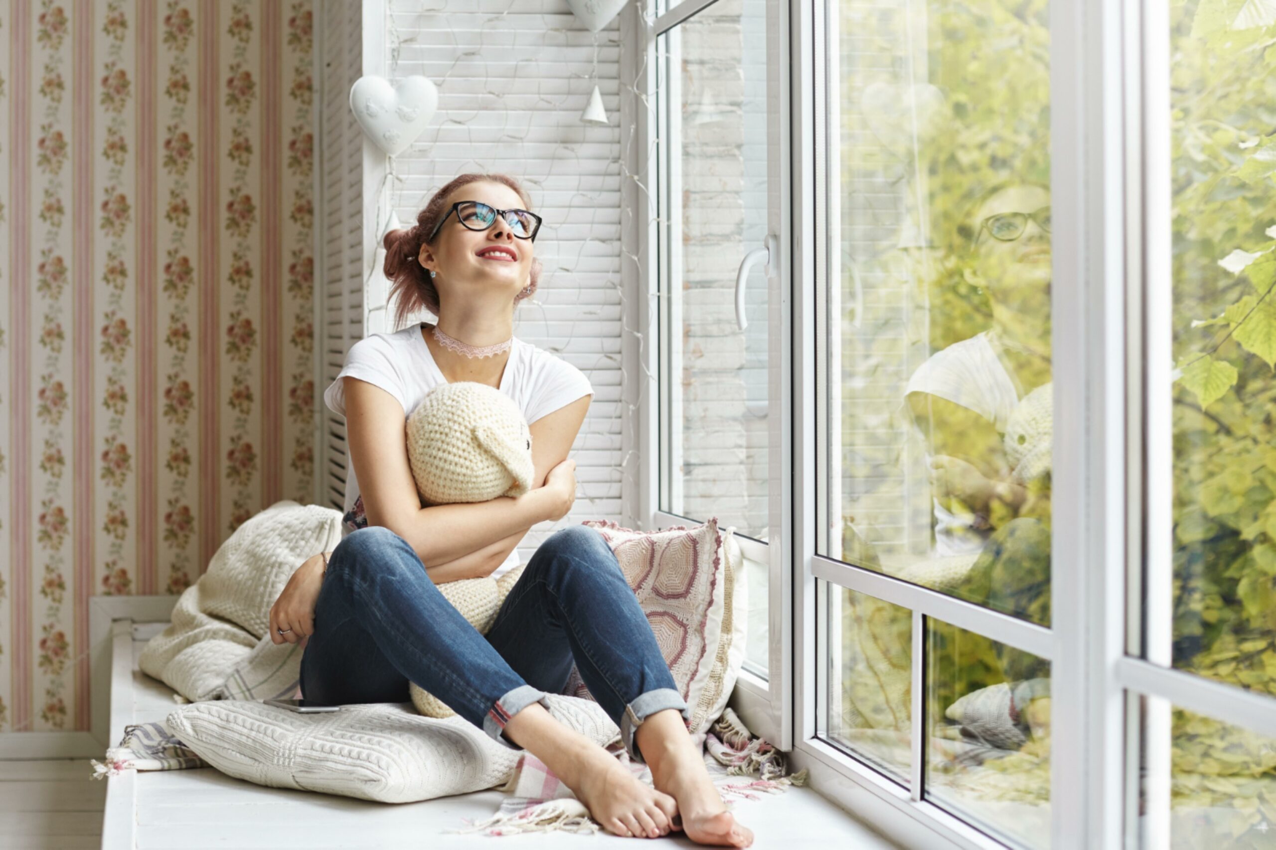 young girl looking in window