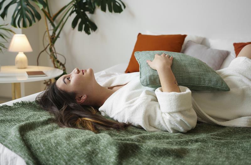 woman lying on a clean bed