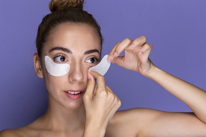 woman applying eye pads