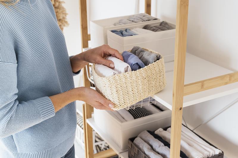 shelf with baskets of clothe