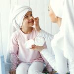 mom playing with cosmetics with her daughter