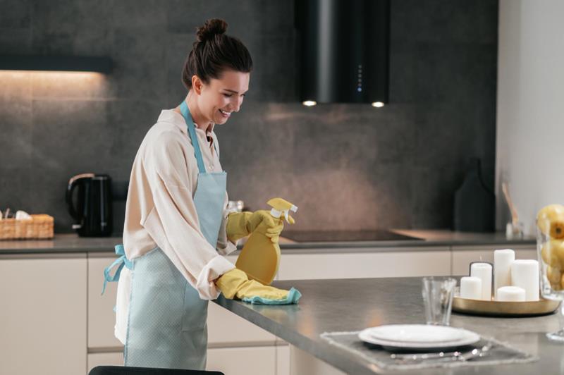 woman disinfecting the surfaces in the kitchen