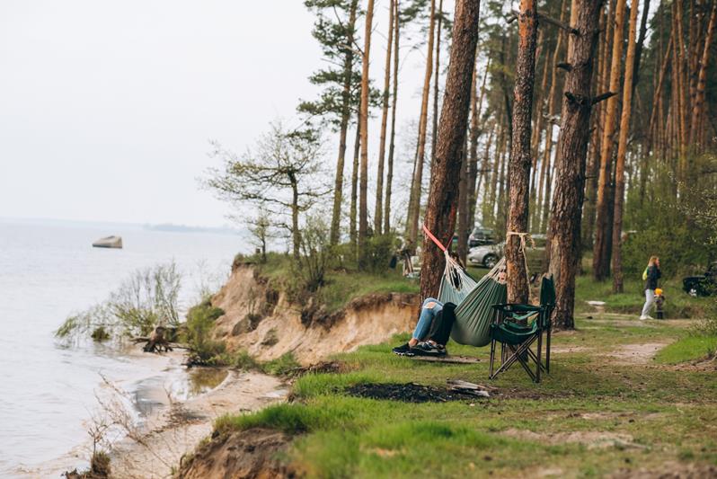 couple relaxing in a hammock near the water