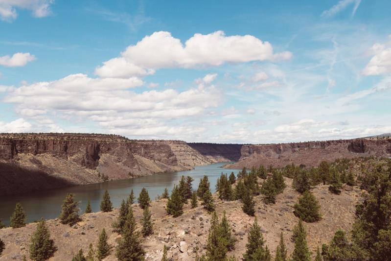 river surrounded by hills in a deserted-area under the sky