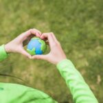 woman holding the colorful plasticine planet