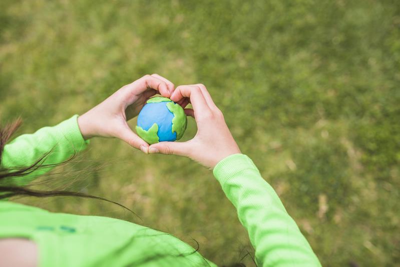 woman holding the colorful plasticine planet