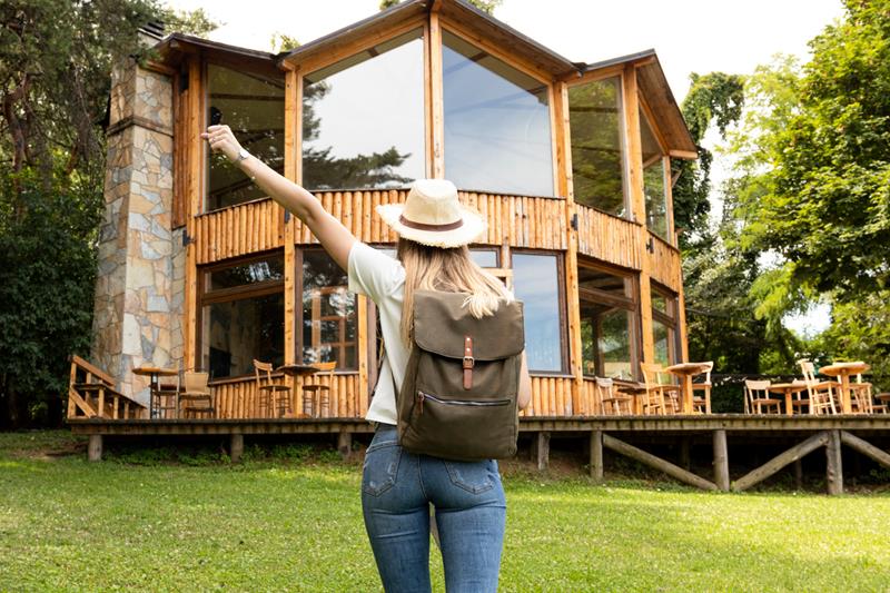 woman in front of a modern house