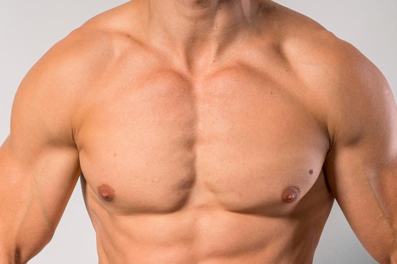 fit shirtless man showing pecs