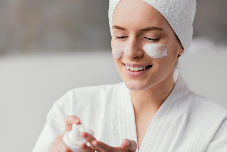 woman using a white face cream