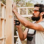 carpenter man using a tape measure