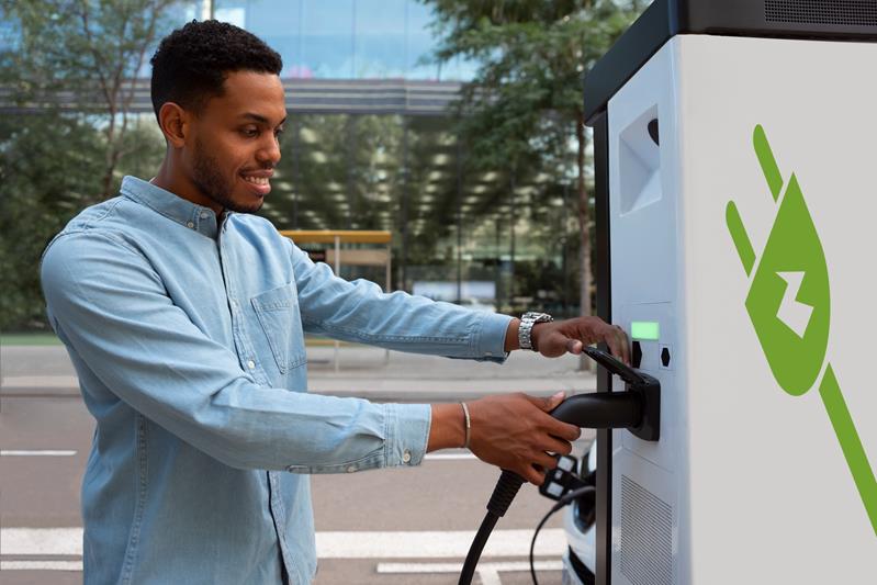 man charging electric car