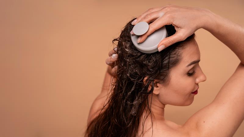 woman giving herself scalp massage