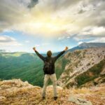 man on top of mountain