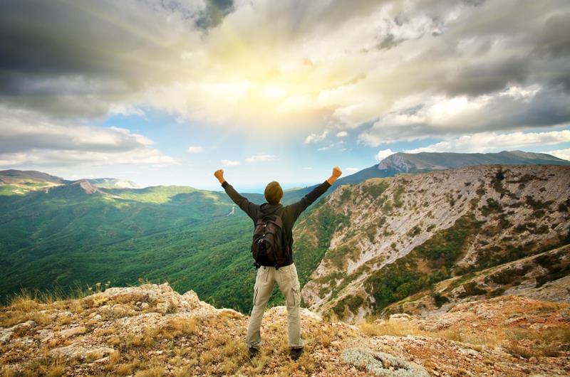 man on top of mountain