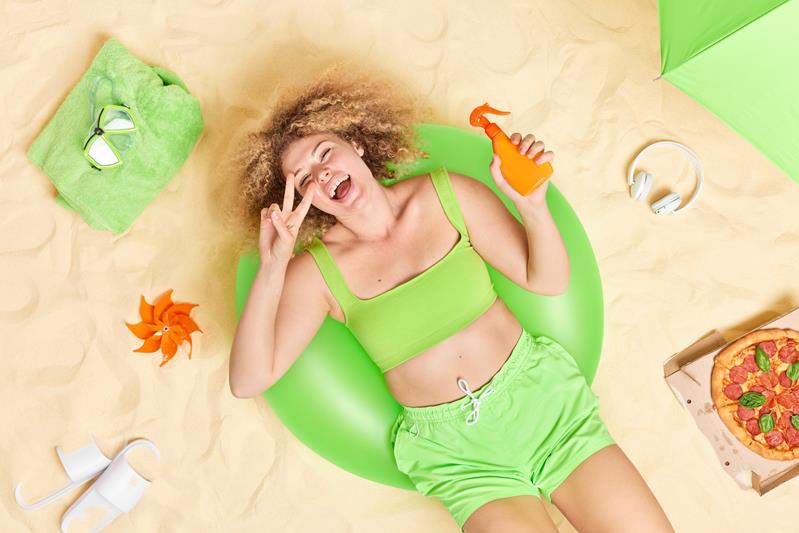 woman lies on green inflatable swim ring