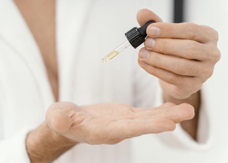 man using natura oils for his face