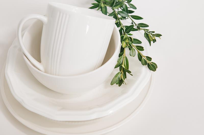 white dishes of three plates and a cup