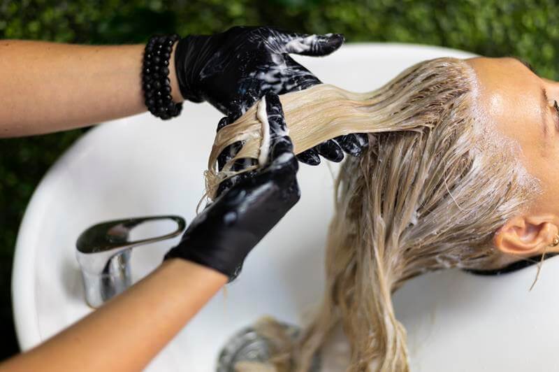 Person applying plant-based hair dye