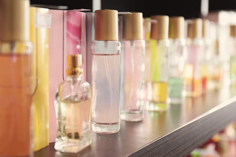 Several perfumes displayed on a shelf